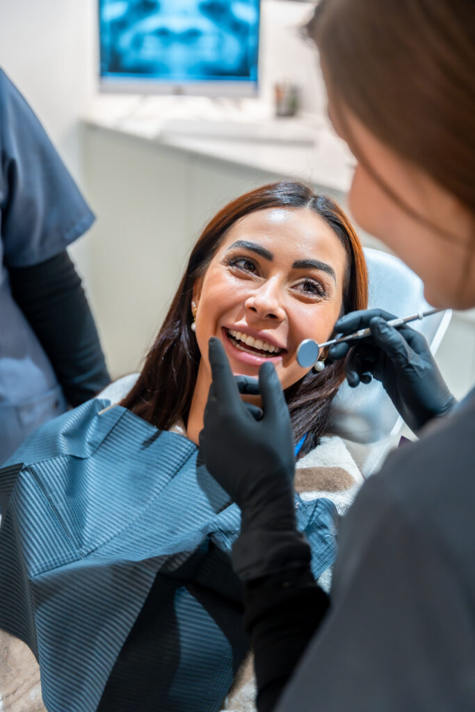 A smiling patient receiving personalized dental care from a dentist at our Ann Arbor dental office.